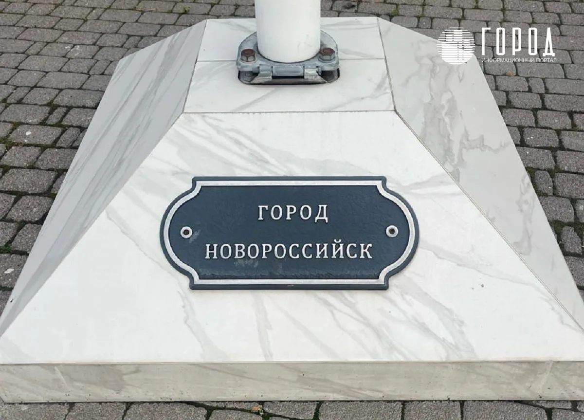 Табличка под флагом города-героя Новороссийск у здания Заксобрания Краснодарского края